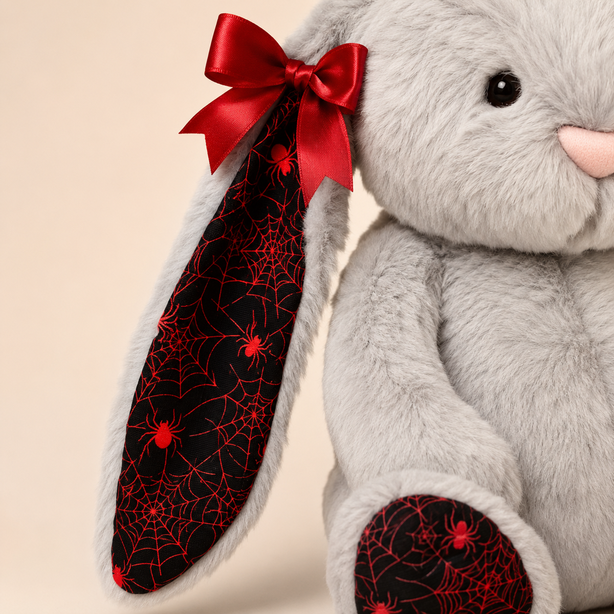 Close-up of the spider-web ear lining and red bow